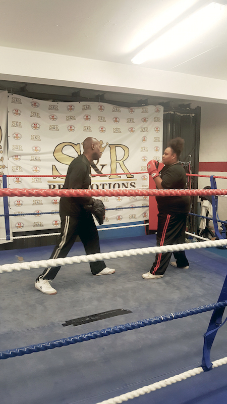 Rob practices pads punching work with a female  student at the Isleworth Boilerhouse Gym