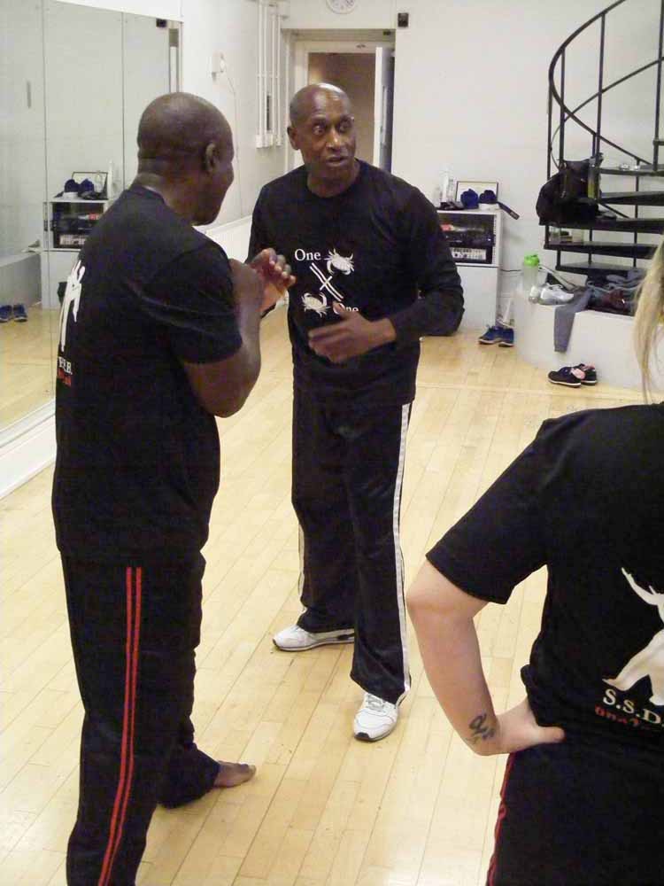 Rob instructs a student at Richmond Olympus Gym on tecnhnique