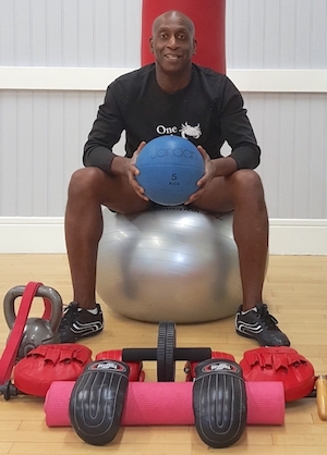 A pture of Rob at the Richmond Olympus Gym, surrounded by personal training equipment