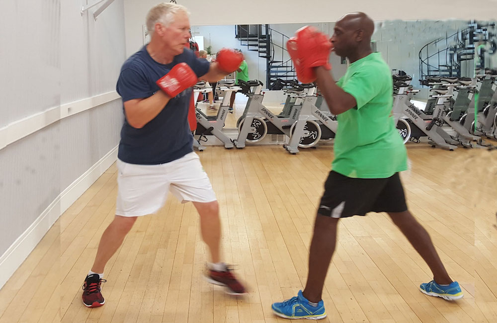 Rob practises boxing with a personal training student