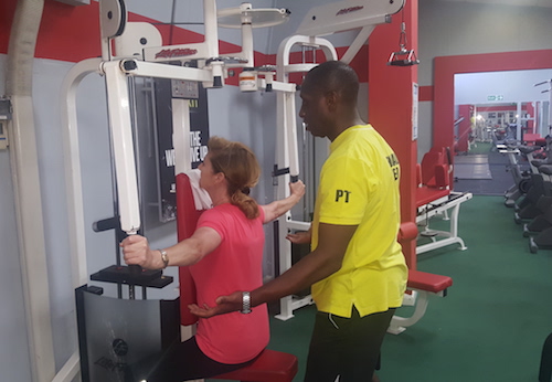 Rob trains a female  student on weights as part of the weight training programme at Richmond Olympus Gym 