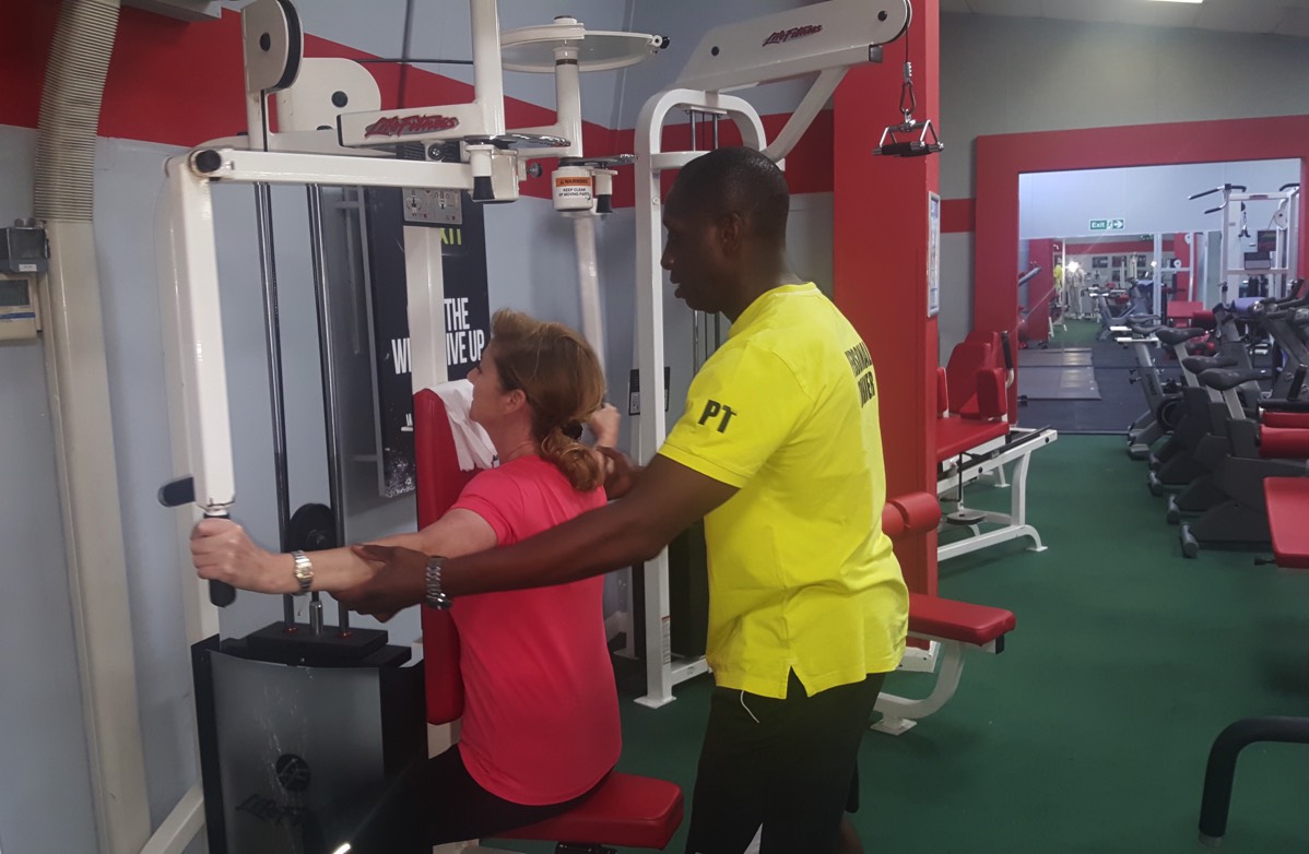 Rob takes a client through a weight traing personal training session
