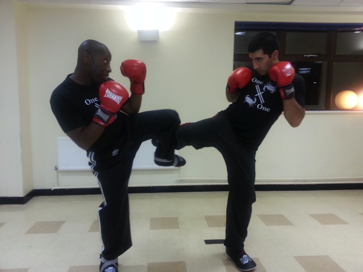 Rob and a Student pose for a kickboxing sparring session